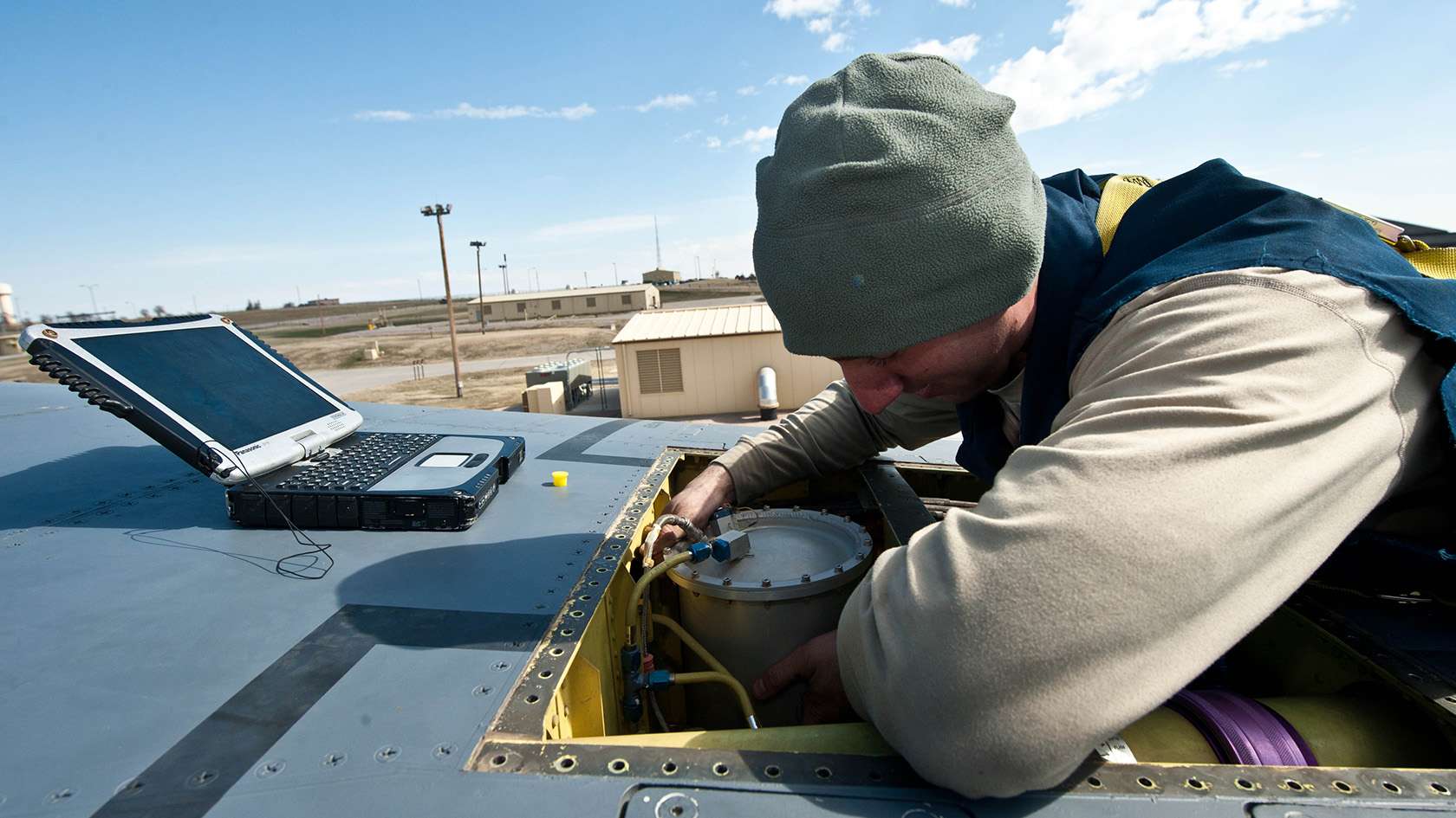 airman maintaining electrical system on aircraft